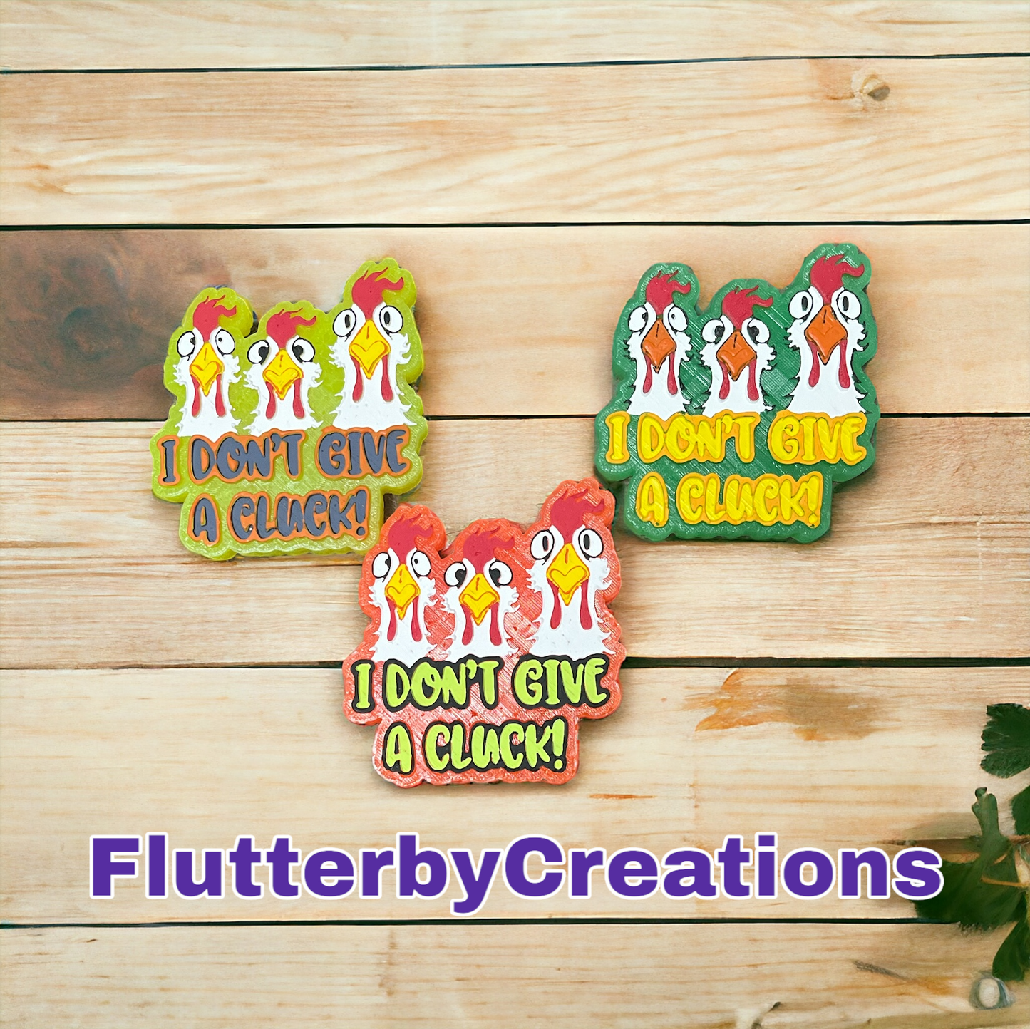 three decorated cookies on a wooden surface with the words i don't give a