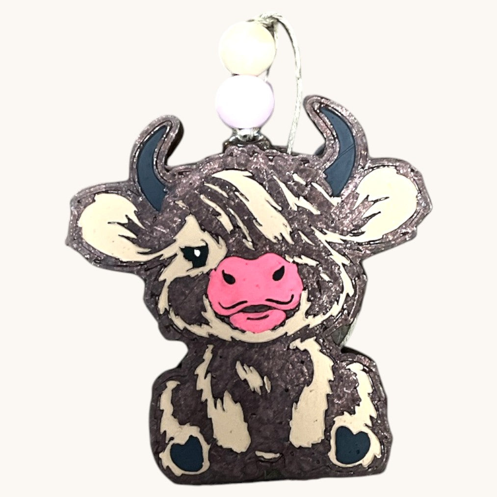 a cow is sitting on top of a tree stump