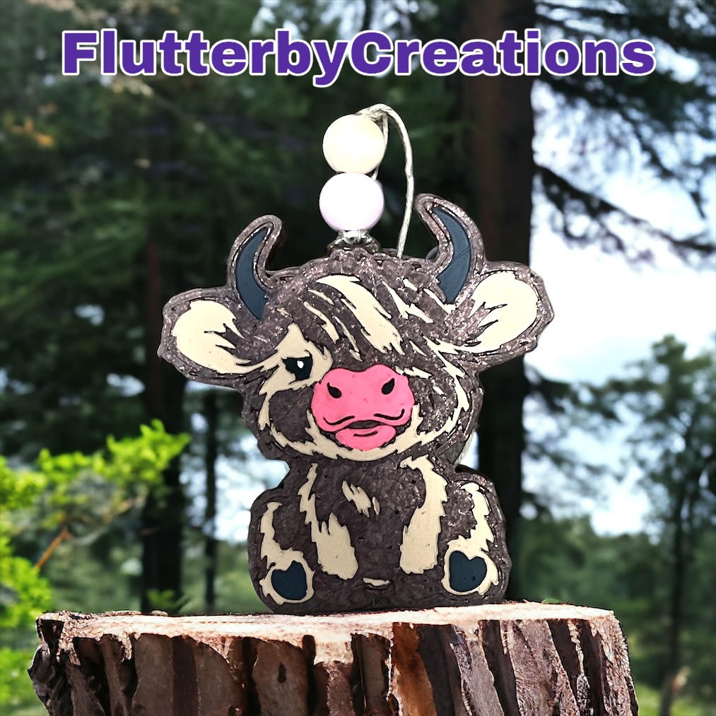 a cow is sitting on top of a tree stump