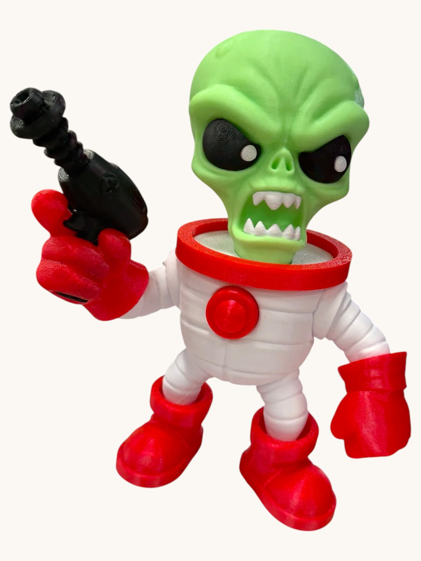 Flutterby Creations 3D printed green alien ranger toy with a glowing head, holding a black space blaster and wearing a white suit with red accents.