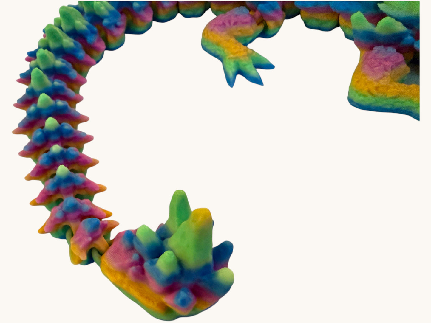 Flutterby Creations Elder Rock Dragon toy with rainbow colours and rock-like details.