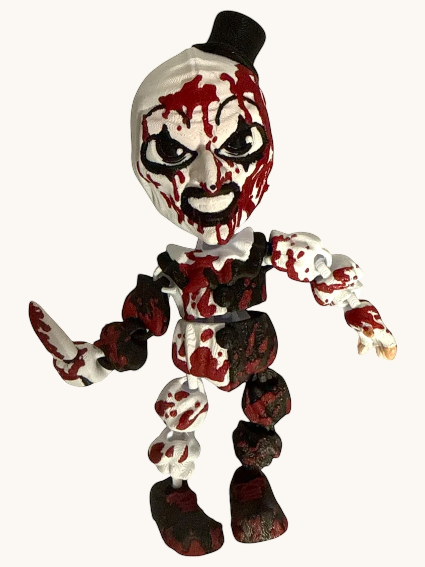 Flutterby Creations horror Clown figure with white face, black top hat, and blood splatters. Holding a knife.