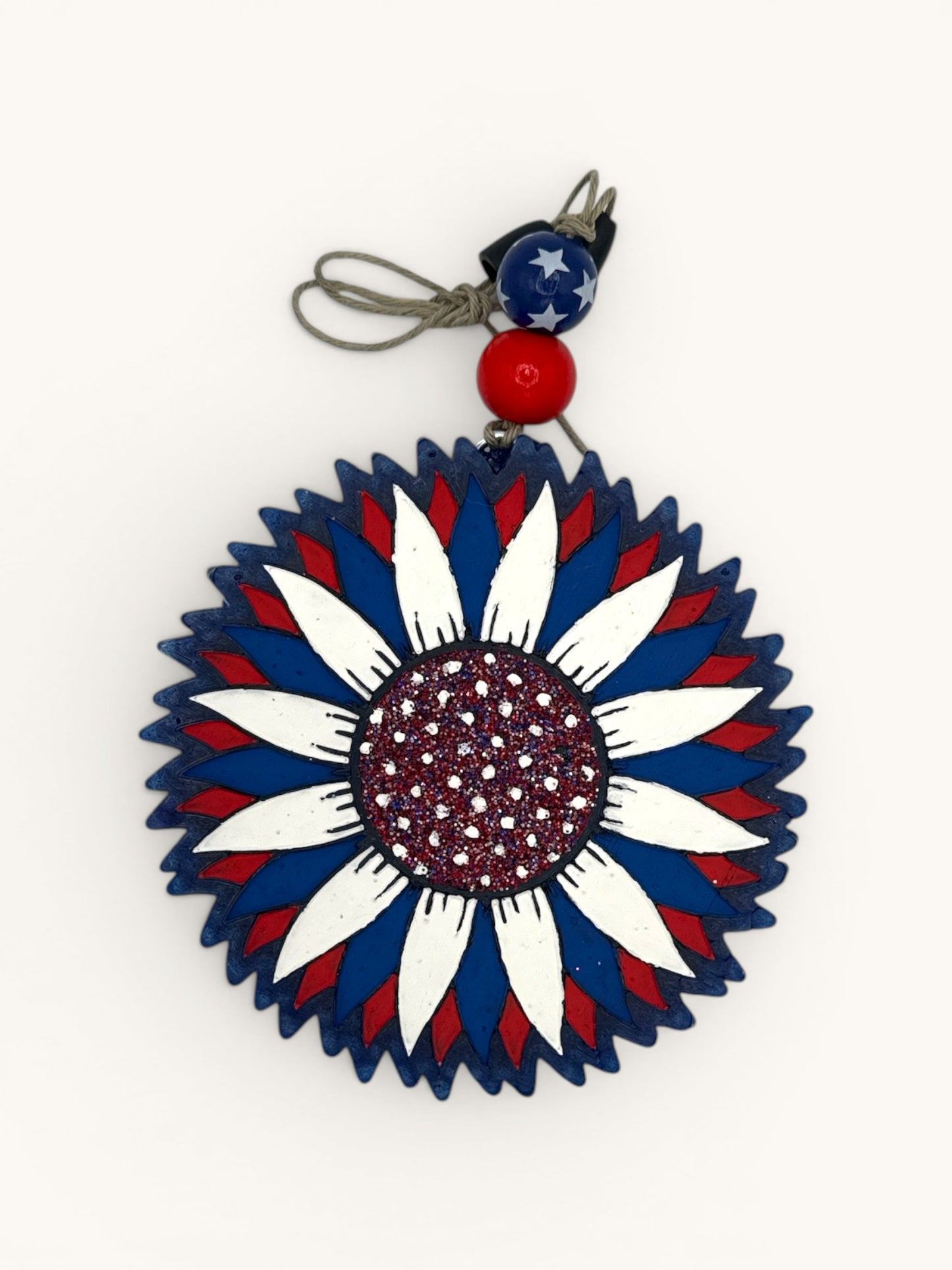 Flutterby Creations patriotic sunflower car freshie with red, white, and blue petals and glittery center.