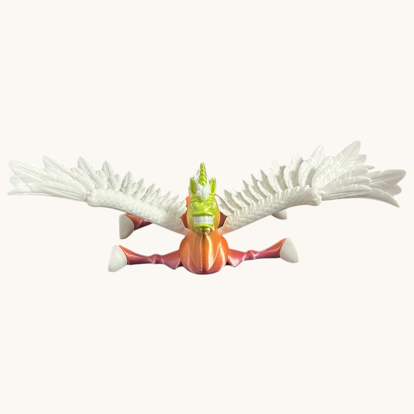 Flutterby Creations Flexicorn 3D printed unicorn toy with green face, orange body, and white wings spread wide.
