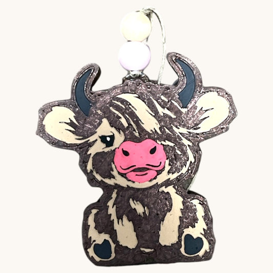 a cow is sitting on top of a tree stump