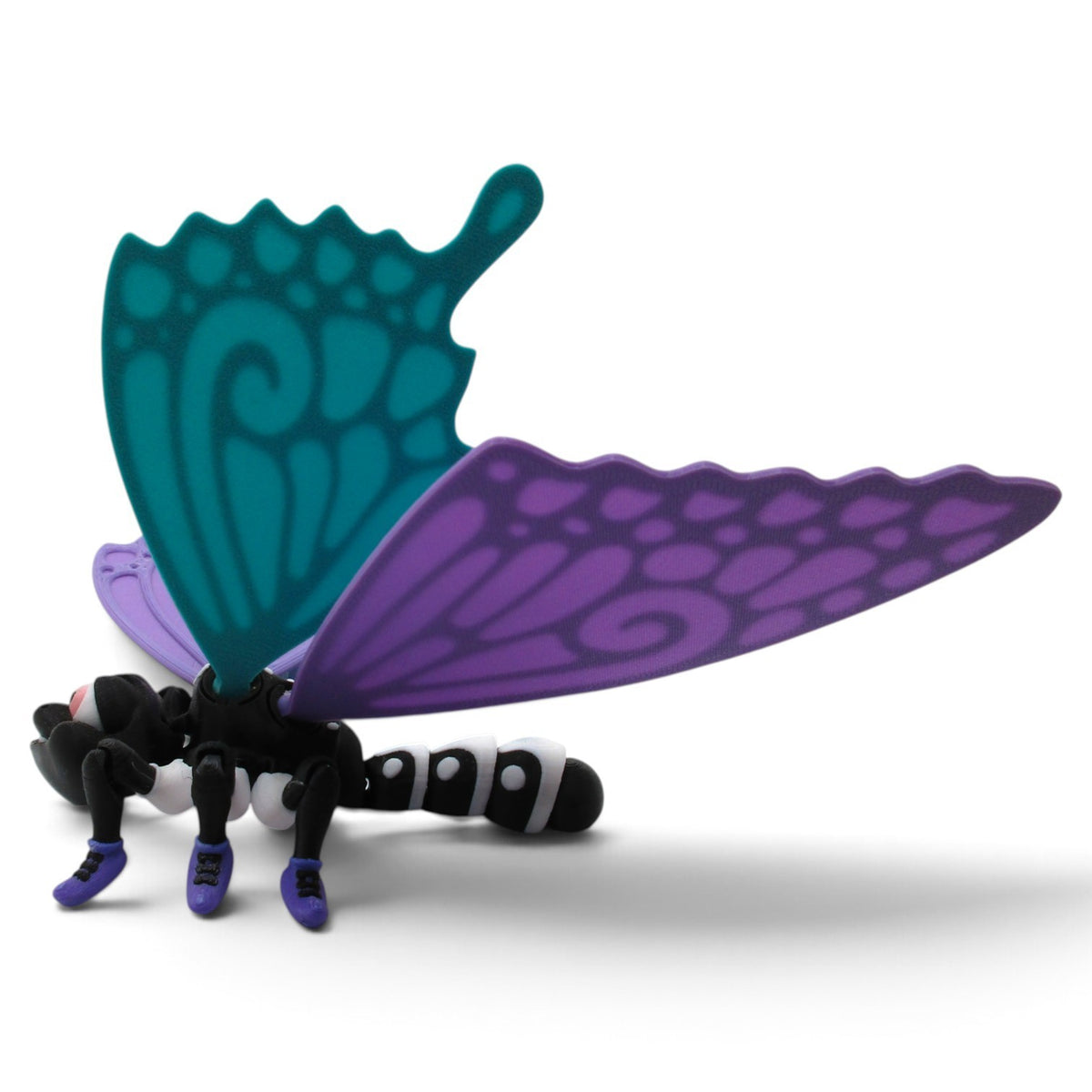 Flutterby Creations 3D printed FlutterShoe display piece featuring a black insect body with teal and purple wings.
