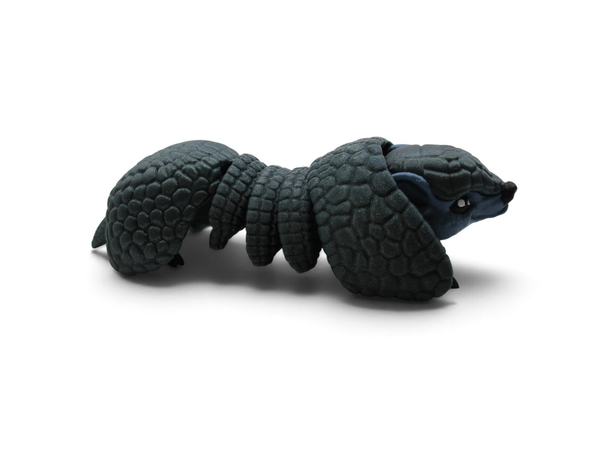 Flutterby Creations Rolo 3D printed flexi armadillo toy with textured dark grey armor scales on a white background
