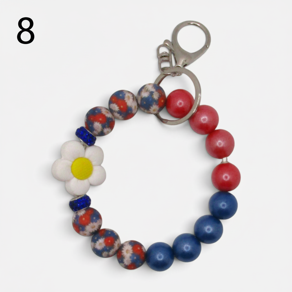 Flutterby Creations beadable wristlet car charm featuring red, blue, and floral beads with a white daisy flower charm.