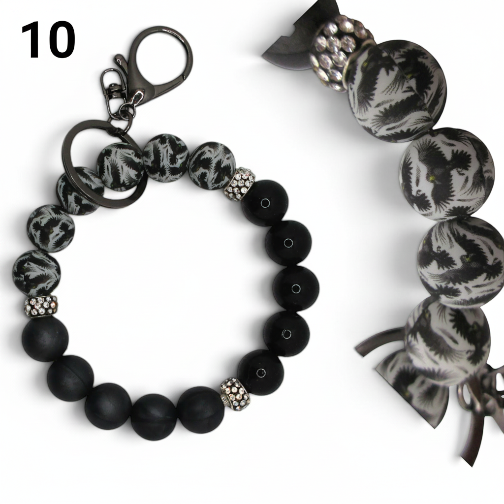 Flutterby Creations beadable wristlet car charm with black matte, crystal, and patterned beads on a metal keyring.