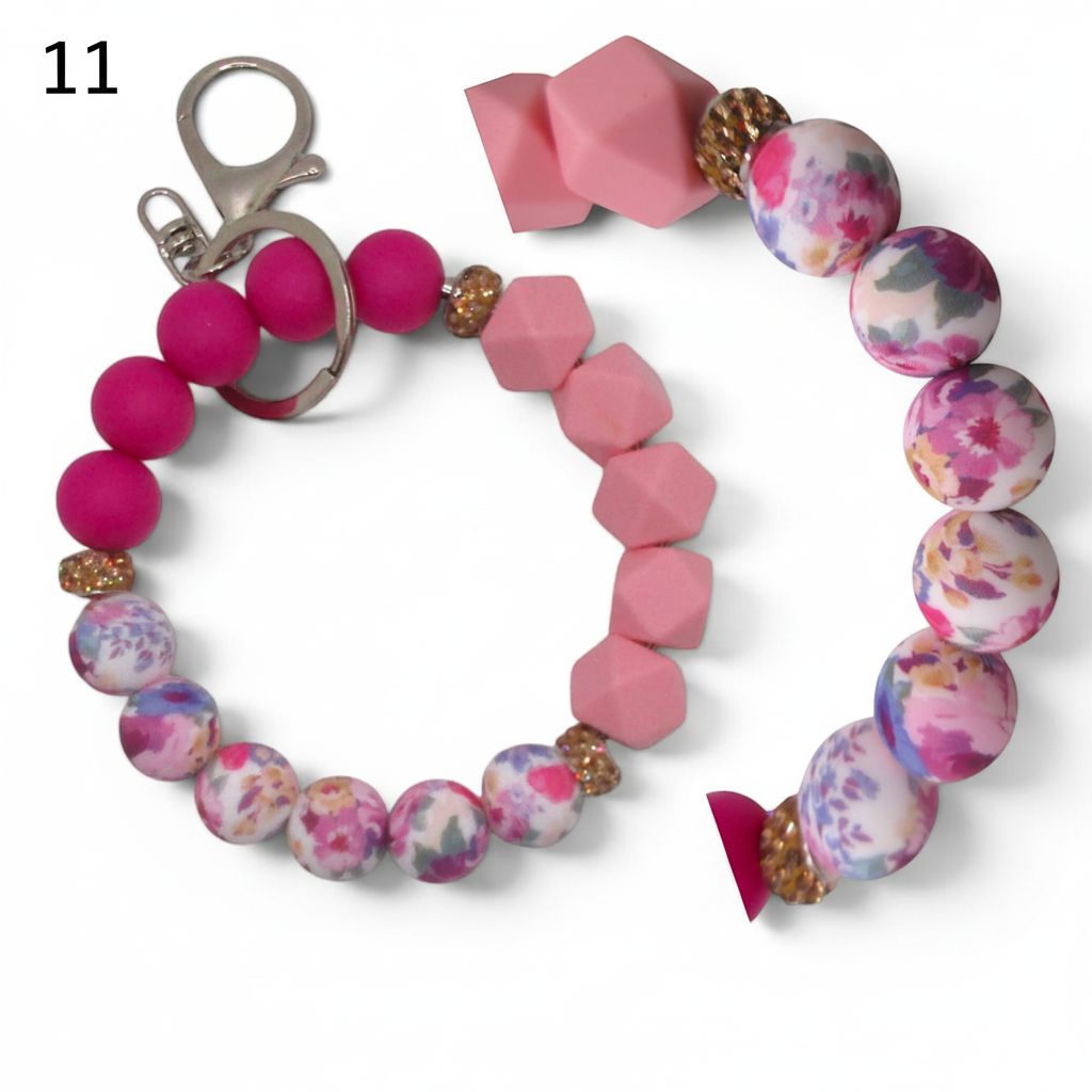 Flutterby Creations beadable wristlet car charm with pink silicone beads, floral patterned beads, and gold accents.