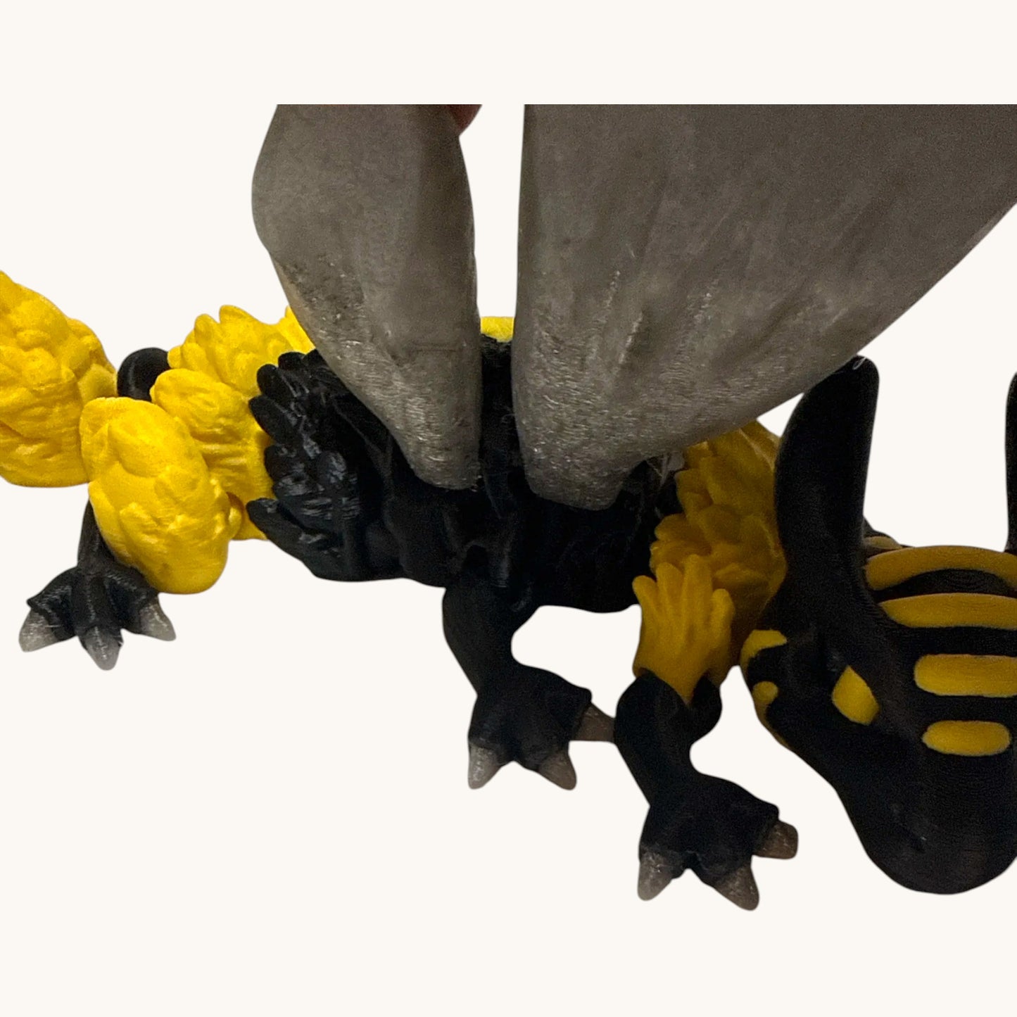 Flutterby Creations Bee Dragon, a 3D-printed fantasy figurine with black and yellow bee stripes and translucent wings.