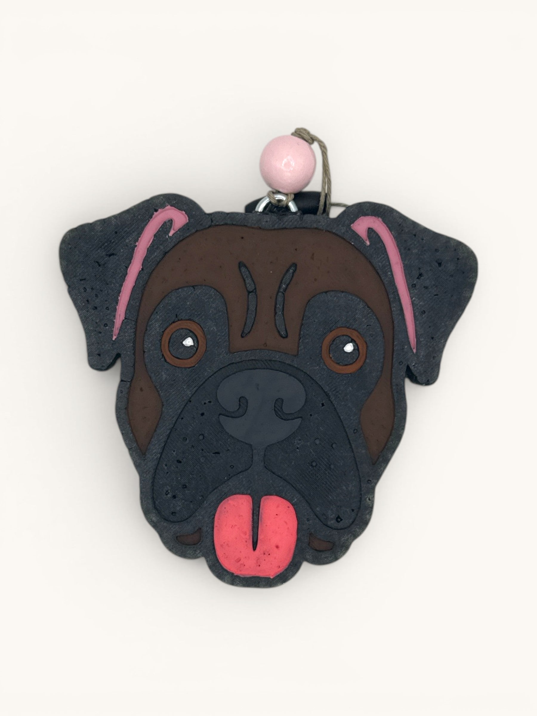 Flutterby Creations Boxer dog car air freshener with brown face, black details, and pink tongue.