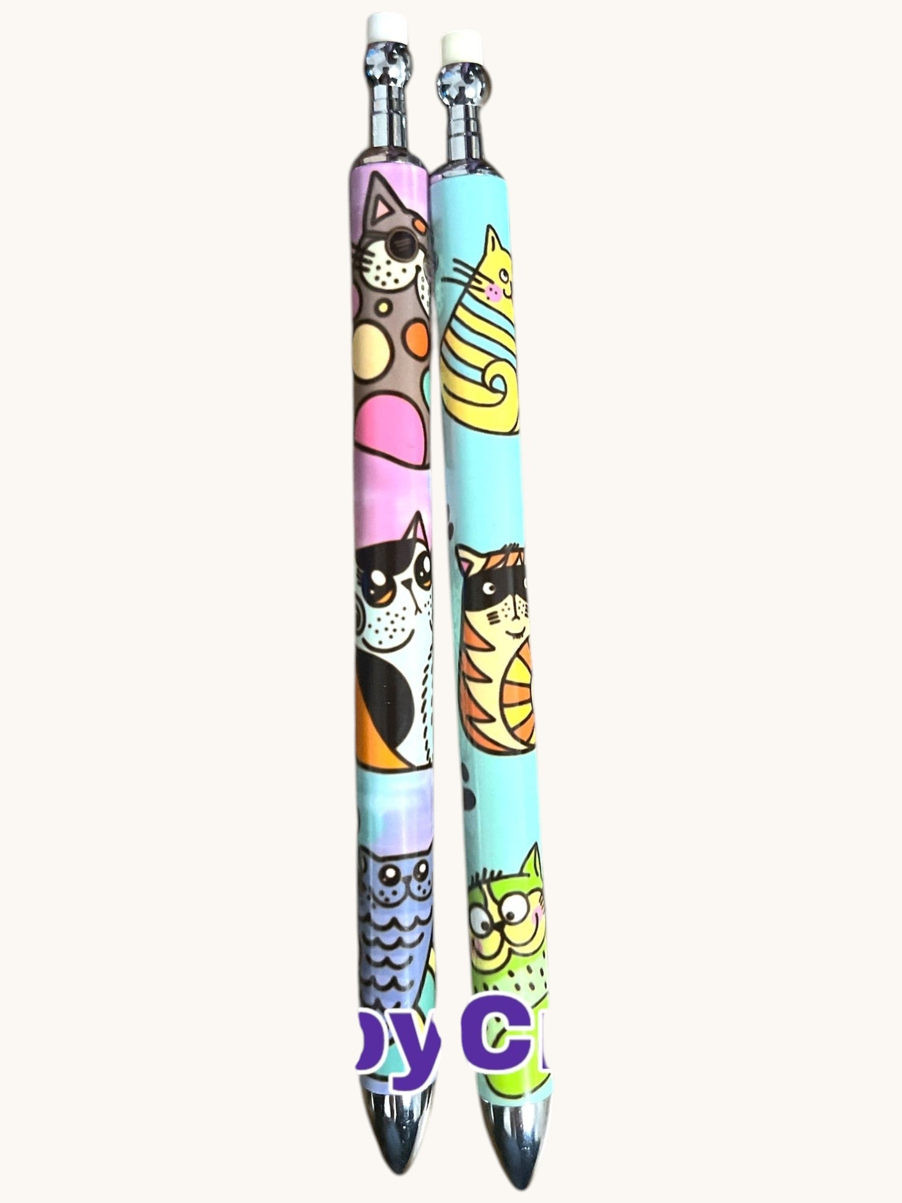 Flutterby Creations mechanical pencils with cute cat and owl designs in pink, blue, and green. Features chrome accents and erasers.