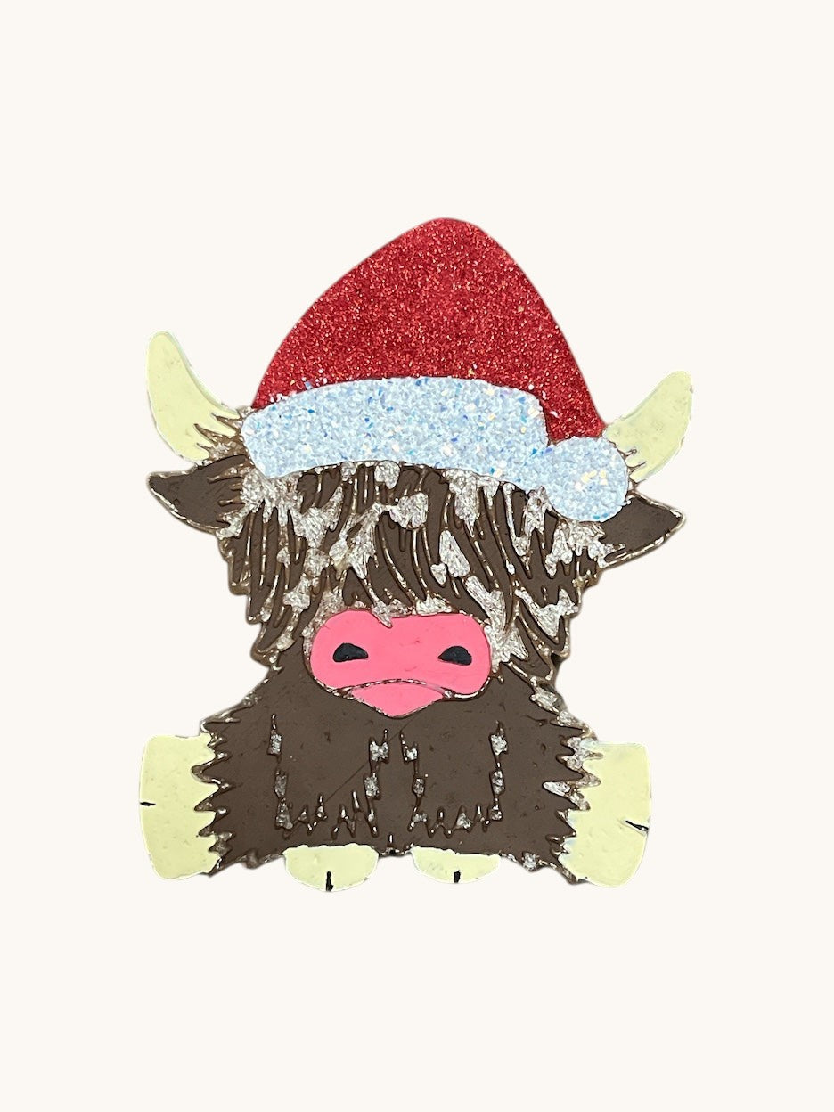Flutterby Creations mini and large  Christmas Highland cow air freshener with red glitter Santa hat and blue trim.