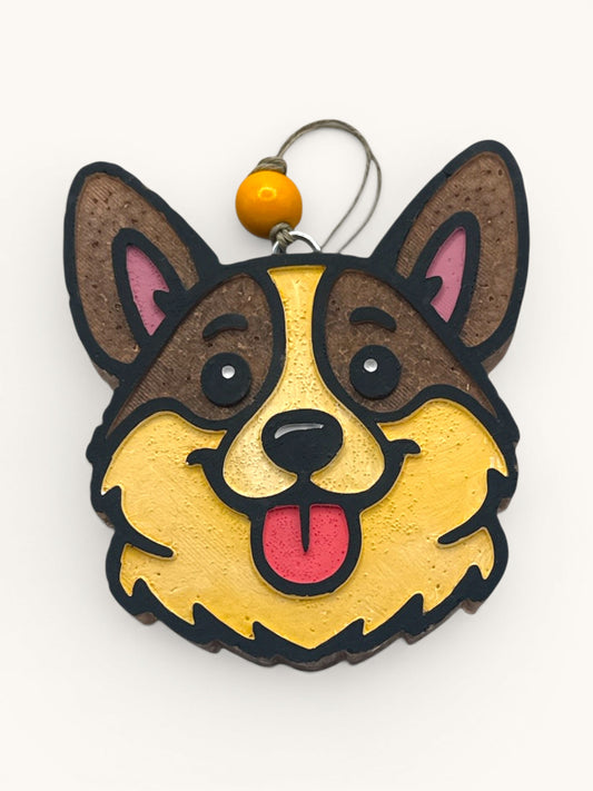 Flutterby Creations Corgi Cutie car freshie, brown and tan dog face with pink inner ears and red tongue sticking out.