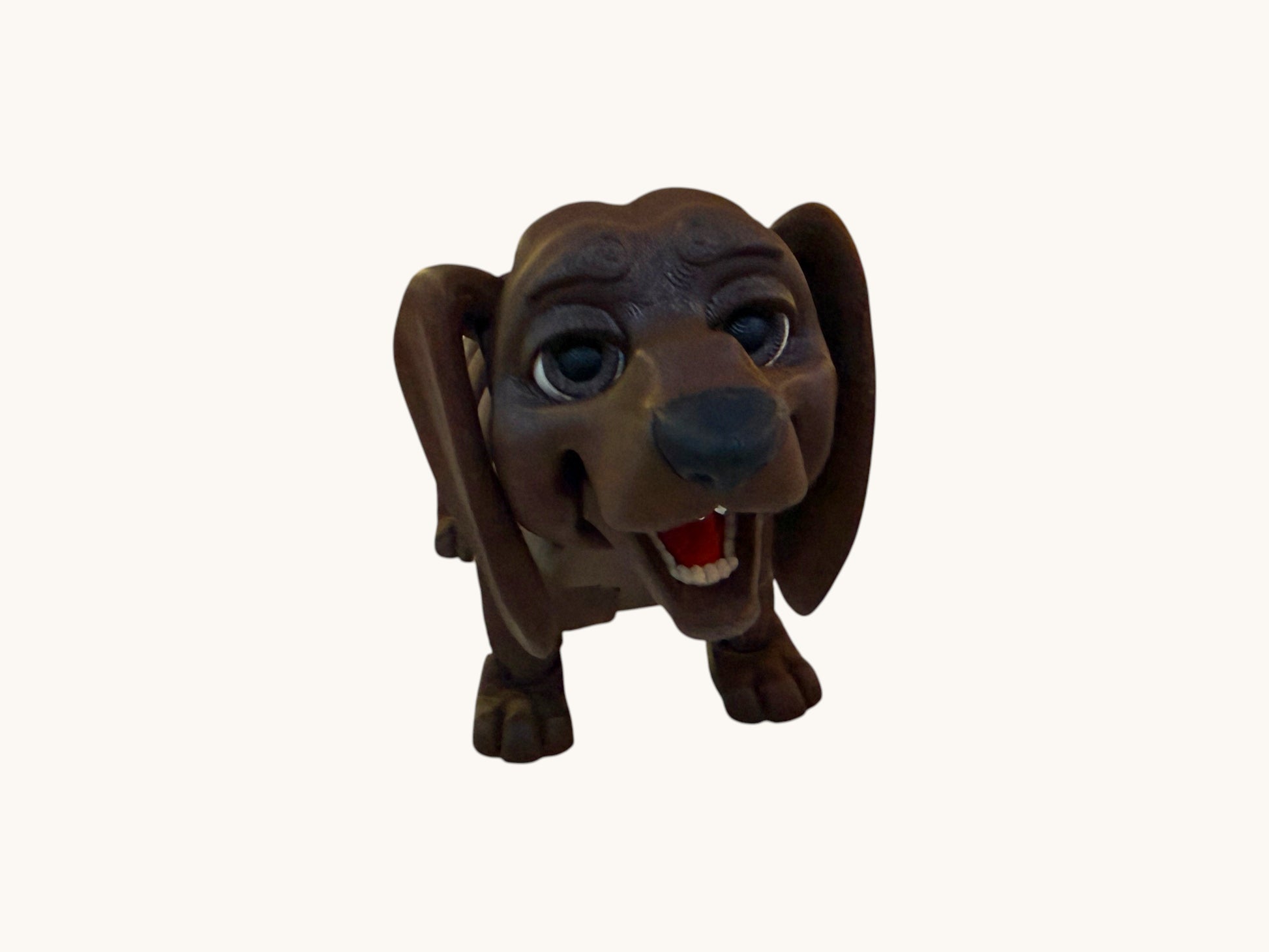 Flutterby Creations brown flexible 3D printed dachshund figurine with large eyes and an open mouth.