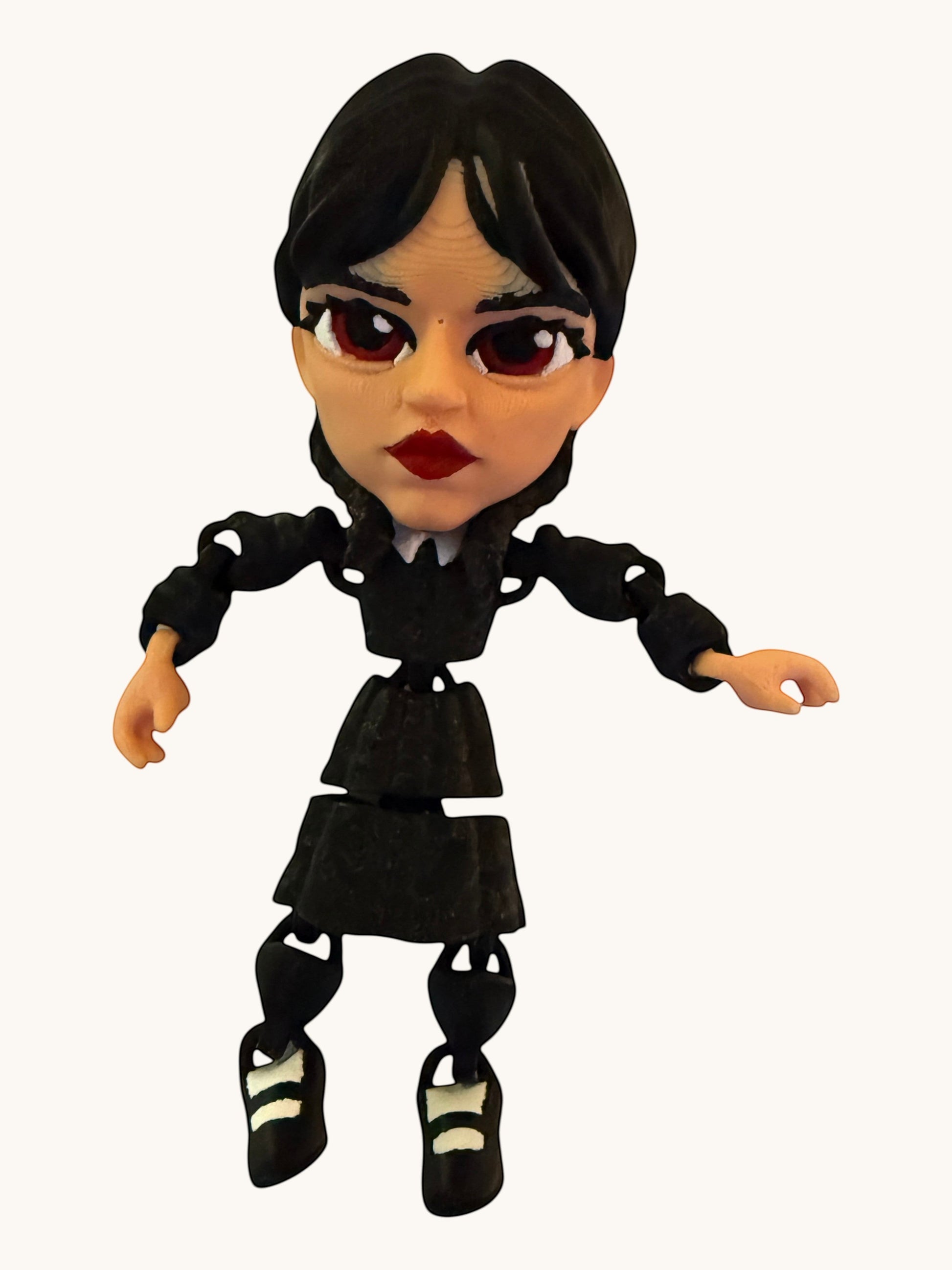 Flutterby Creations articulated doll wearing a black dress and striped shoes.