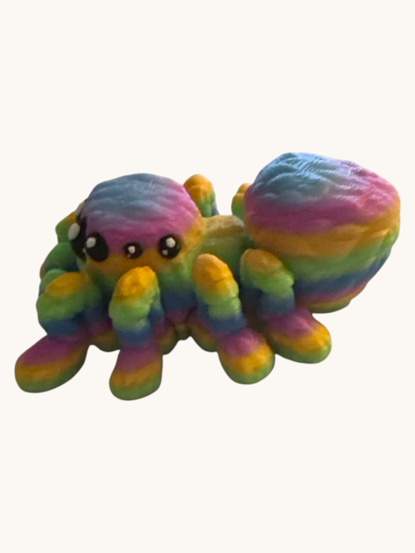Flutterby Creations Flexi Spider, a 3D printed toy with rainbow-colored segments and articulated legs. Perfect for Halloween decor or fidget toy.