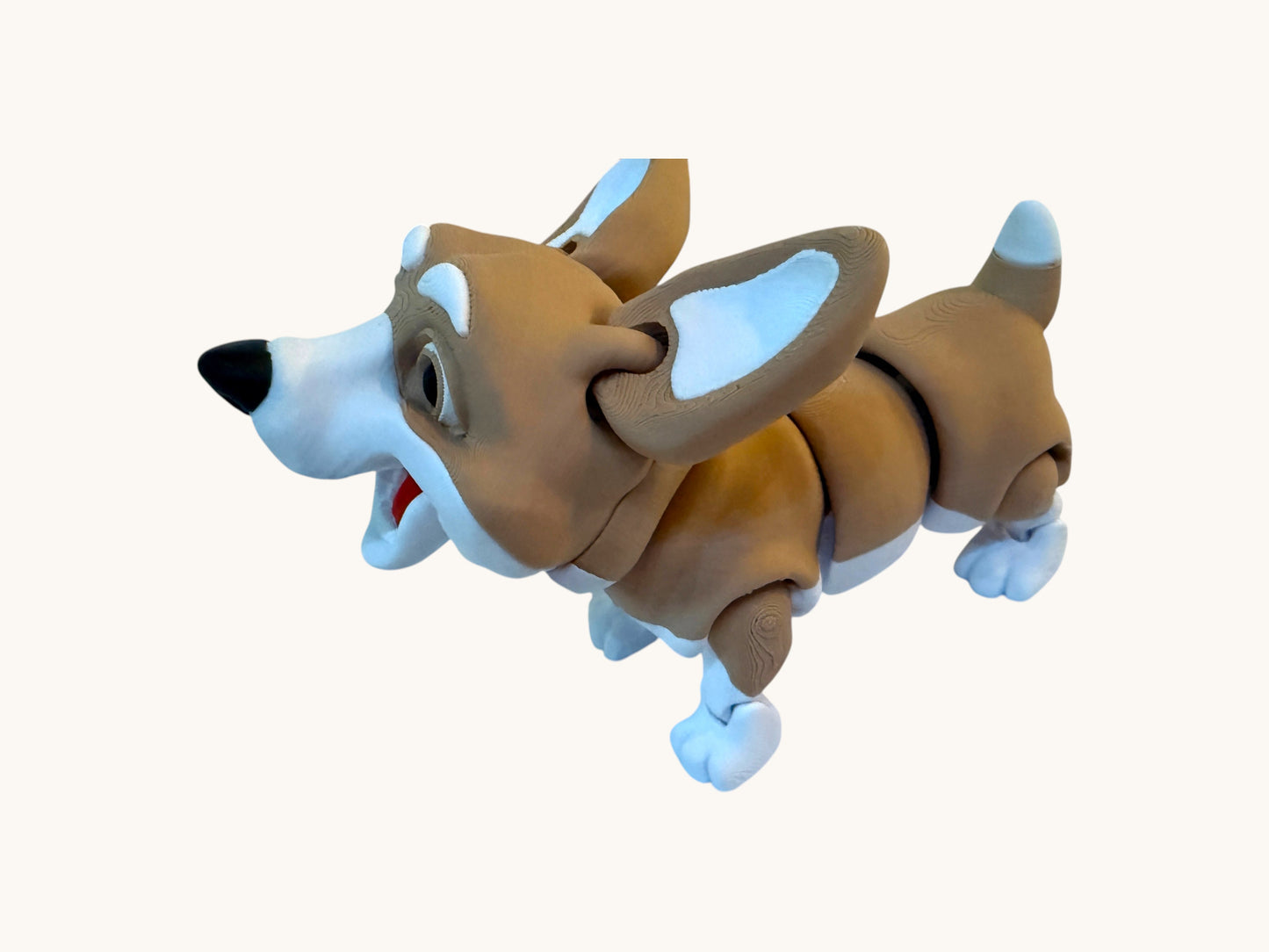 Flutterby Creations brown and white flexible corgi dog toy with articulated joints.