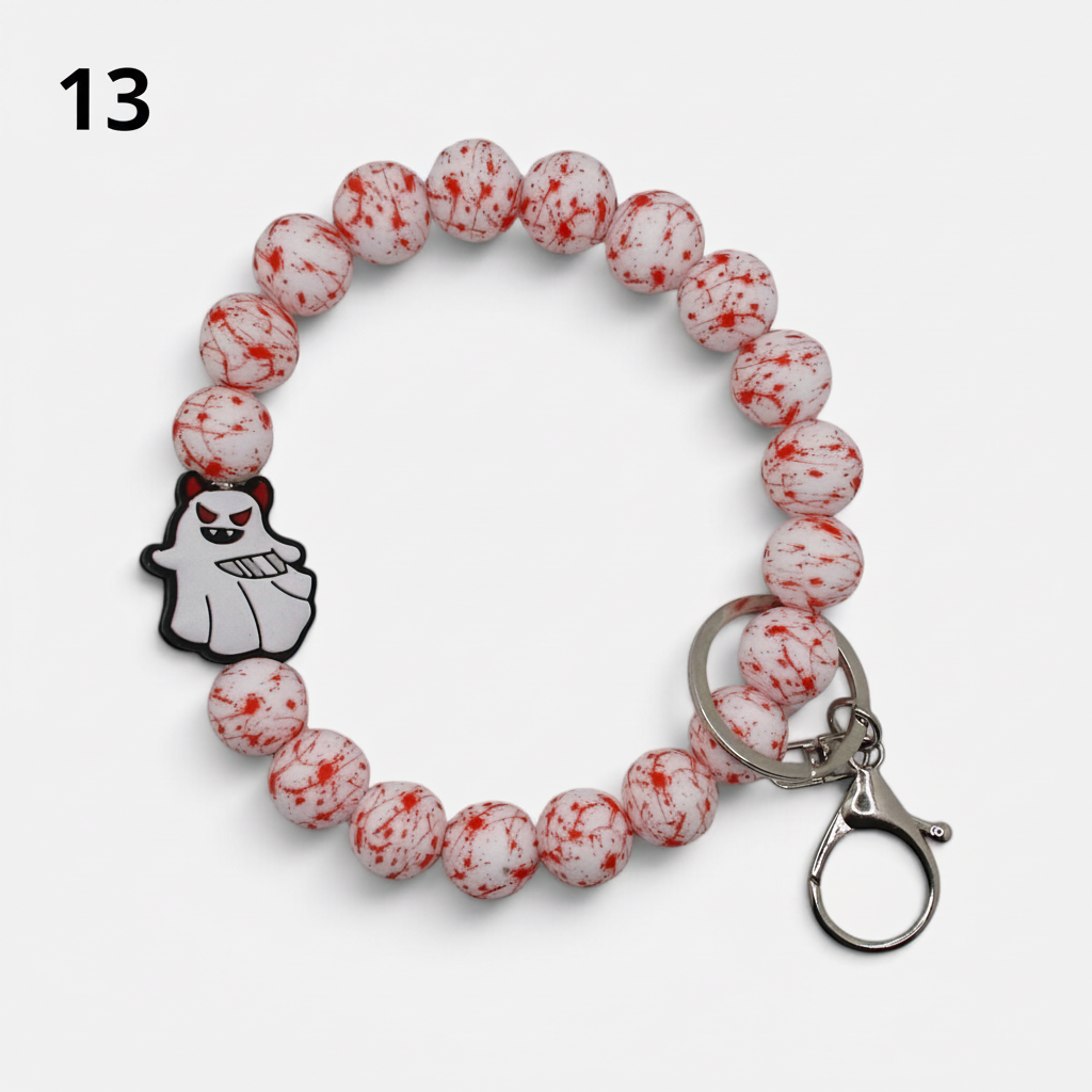Flutterby Creations beadable wristlet with white and red blood splatter silicone beads and a cute ghost charm