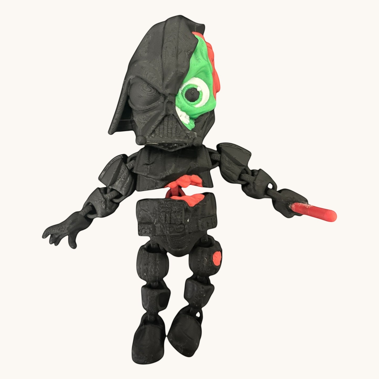 Flutterby Creations Halloween character toy, a black -style figure with exposed green and red innards, one eye visible.