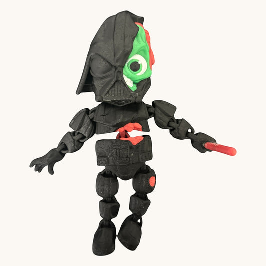 Flutterby Creations Halloween character toy, a black -style figure with exposed green and red innards, one eye visible.