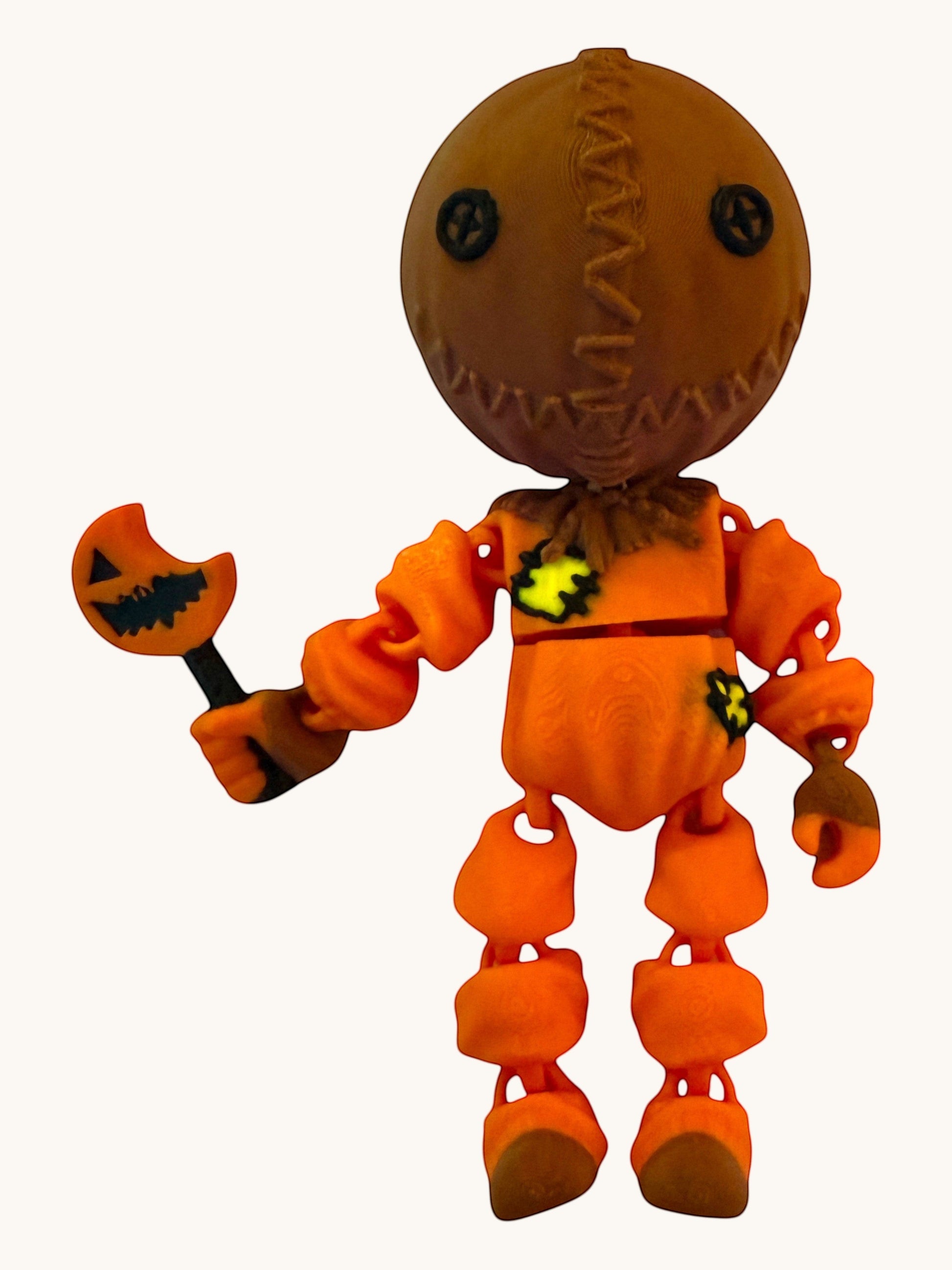 Flutterby Creations Halloween character figure with brown burlap sack head and orange jumpsuit, holding a pumpkin candy stick.