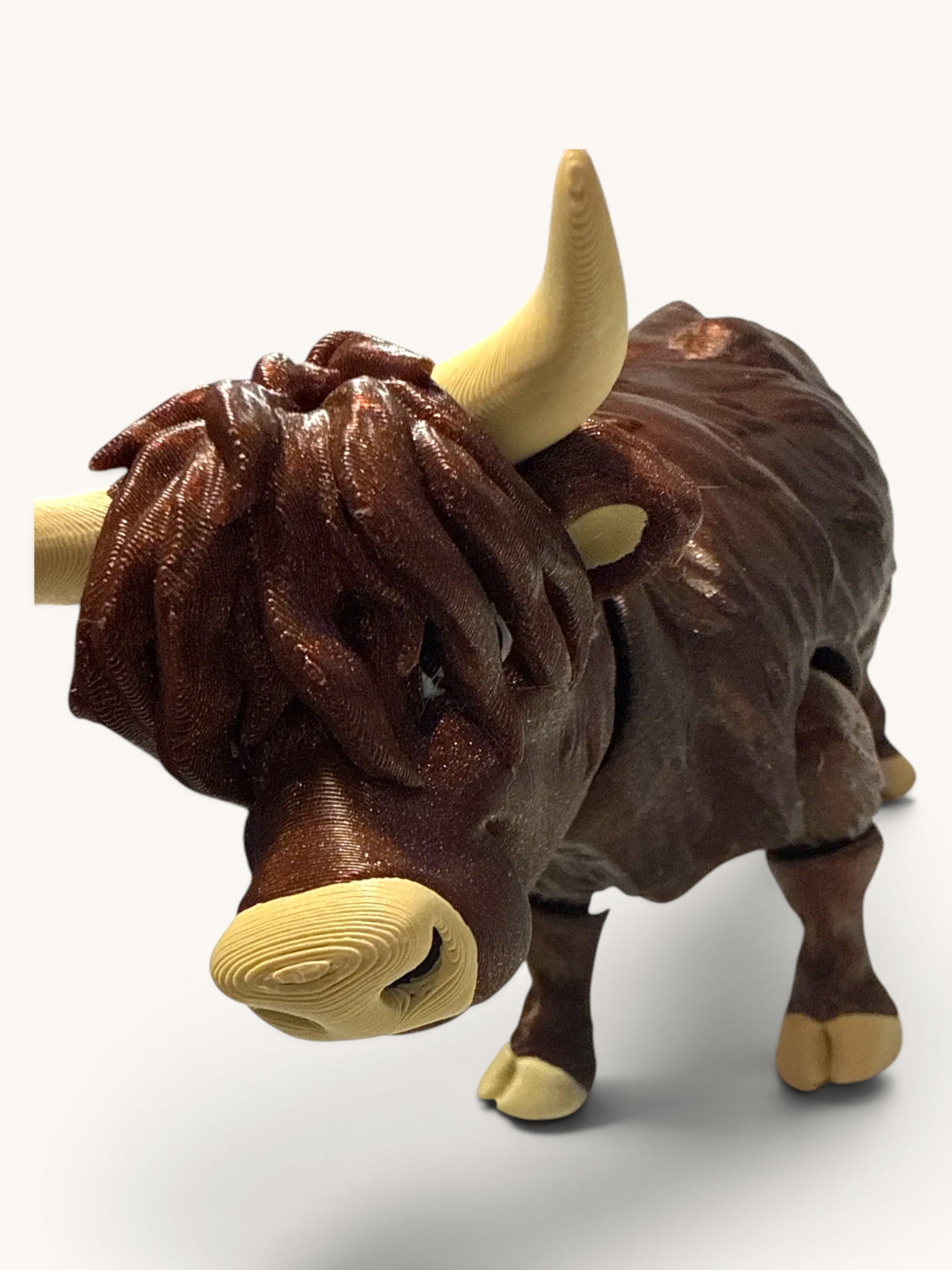 Flutterby Creations 3D printed Highland cow figurine in brown with tan horns and hooves.