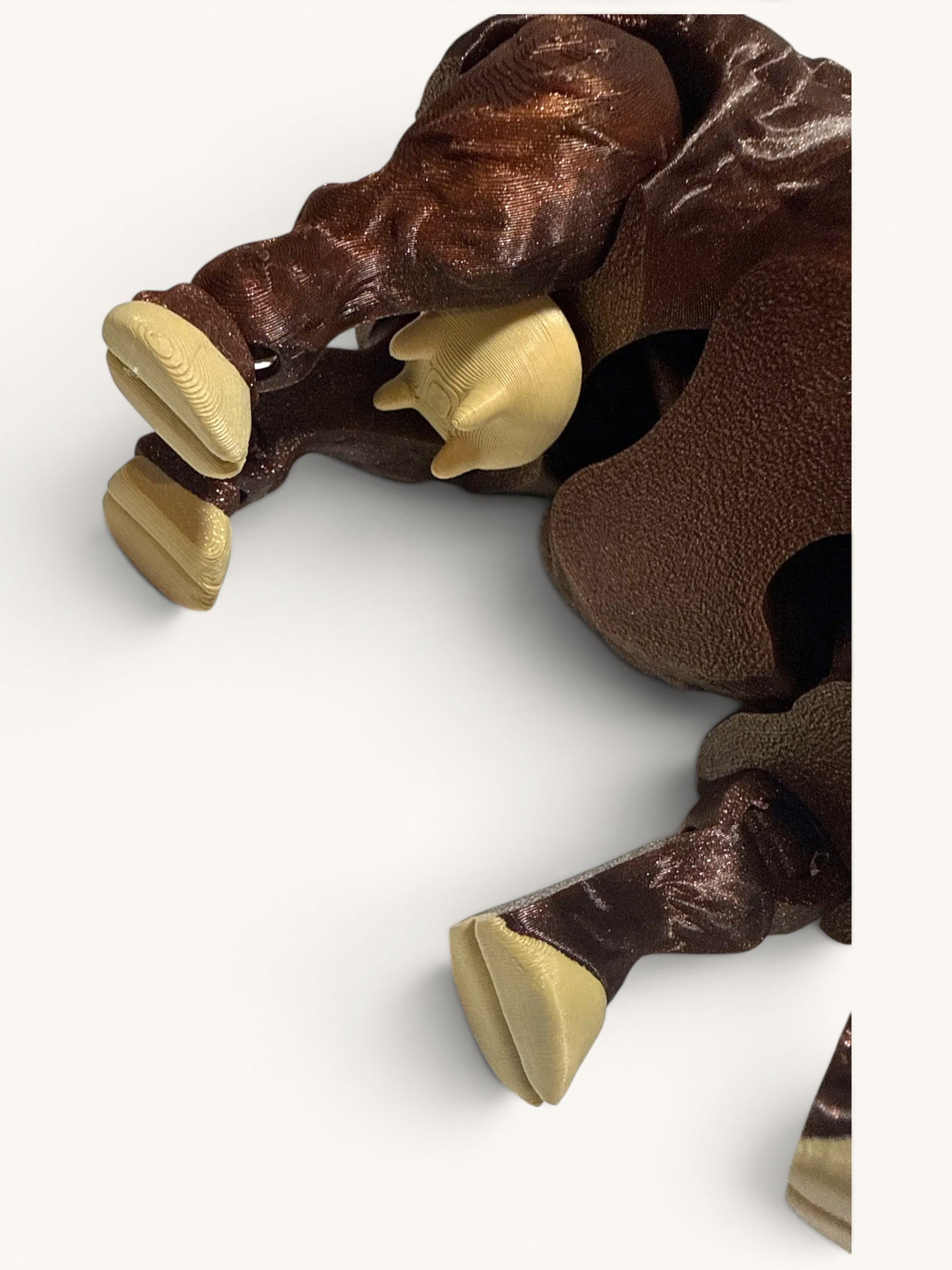 Flutterby Creations 3D printed Highland Cow figurine in brown with tan hooves.