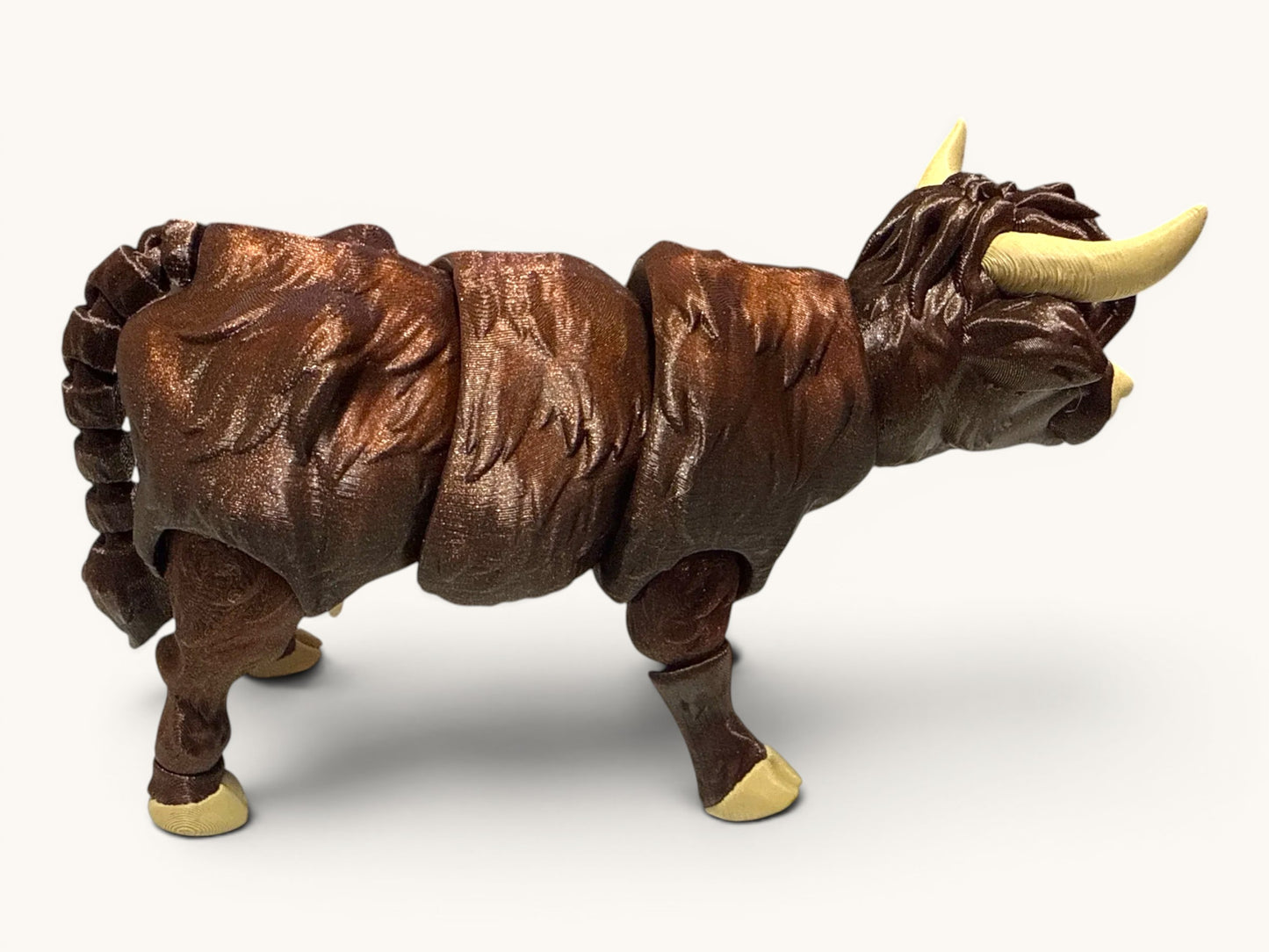 Flutterby Creations 3D printed Highland cow figurine in dark brown with articulated joints and cream horns.