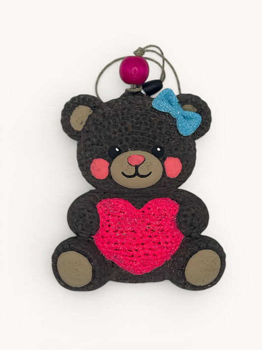 Flutterby Creations knitted-look brown bear air freshener holding a pink heart with a blue bow on its ear.