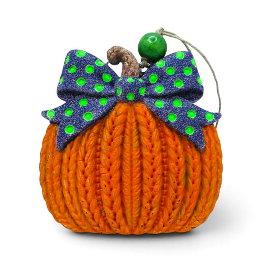 Flutterby Creations 3D knitted pumpkin car freshie with a purple and green polka dot bow and green bead accent.