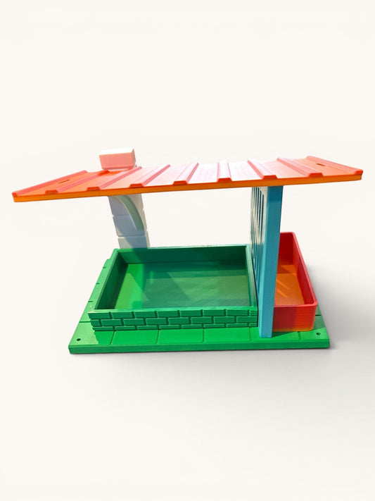 Flutterby Creations Modern Retreat 3D printed bird feeder in green, orange, blue, and white with a sloped roof and brick detail.