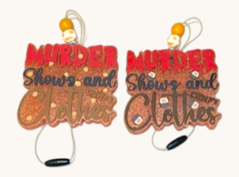 Flutterby Creations murder shows and clothes car freshie with red text and brown textured background. Includes hanging string and beads.