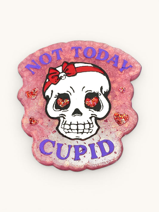 Flutterby Creations pink car freshie with a skull wearing a red bow and glittery heart eyes, saying Not Today Cupid.