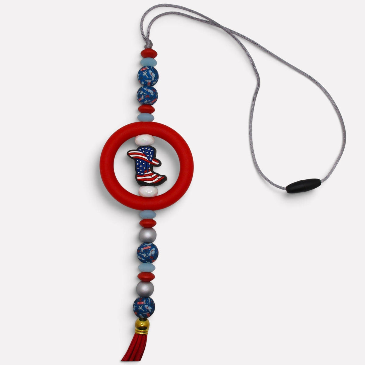 Flutterby Creations handmade beadable car charm featuring a patriotic cowboy boot charm, red ring, and red tassel.