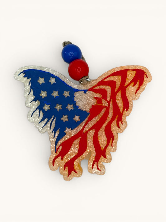 Flutterby Creations patriotic eagle-shaped car freshie with American flag design, red, white, and blue glitter accents.