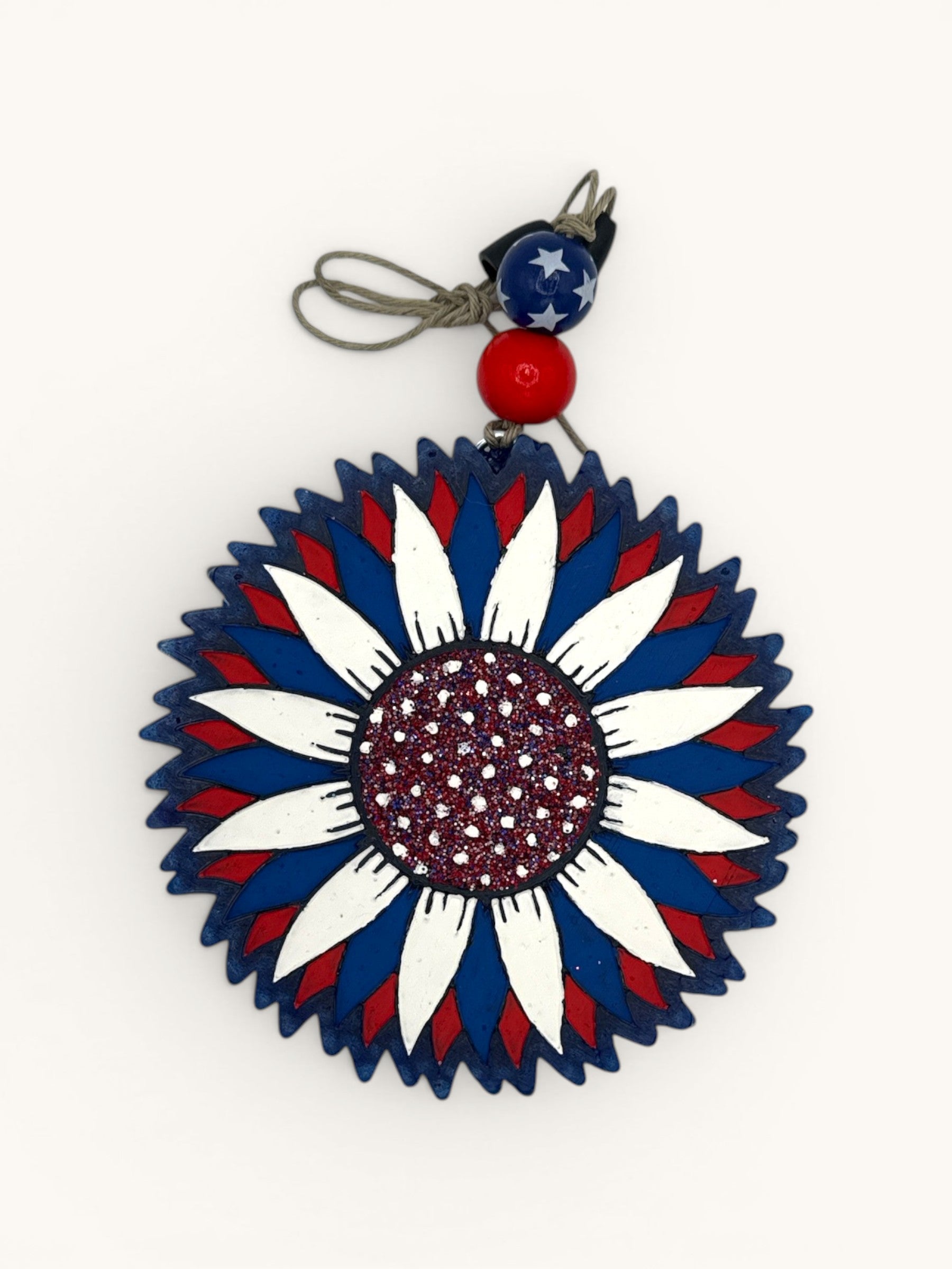 Flutterby Creations patriotic sunflower car freshie with red, white, and blue petals and glittery center.