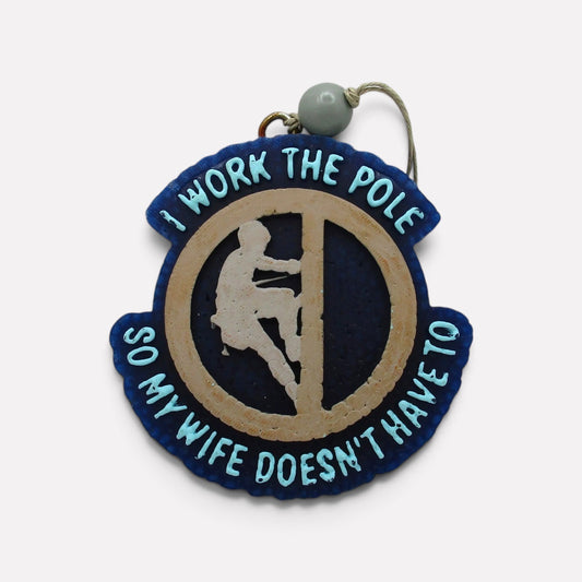 Flutterby Creations Pole Provider car freshie featuring a humorous design with blue and tan aroma beads.