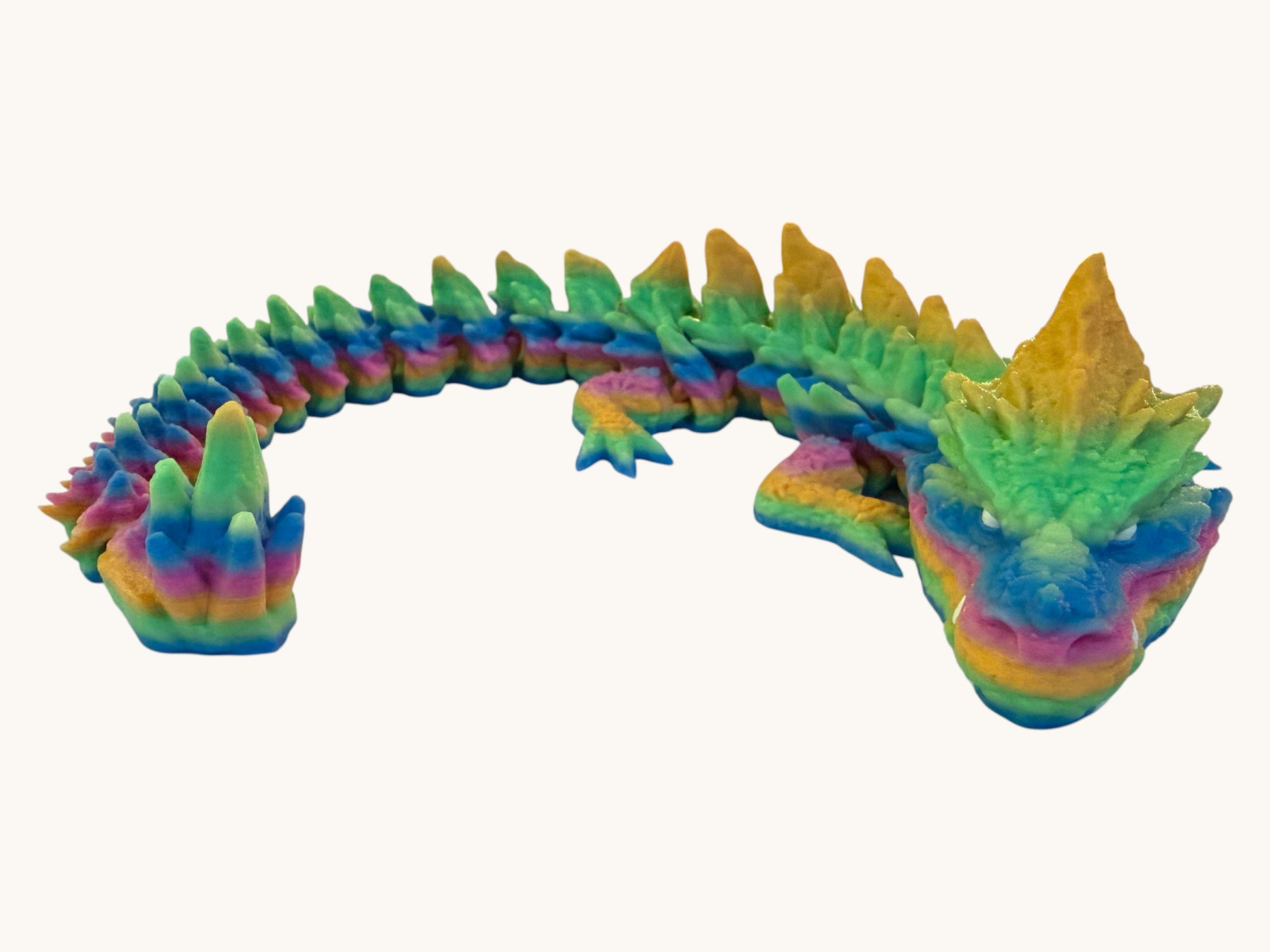 Flutterby Creations Elder Rock Dragon, a flexible rainbow-colored articulated dragon with rugged, rock-inspired details.
