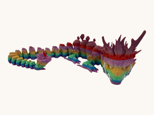 Flutterby Creations rainbow forest dragon figurine with articulated segments and detailed head.