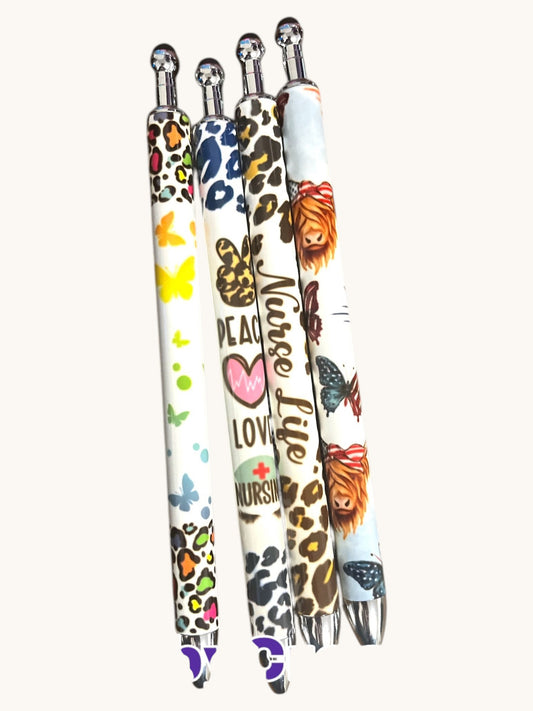 Flutterby Creations set of four refillable pens with interchangeable designs: butterflies, peace signs, leopard print, and a Highland cow. Includes gel ink.