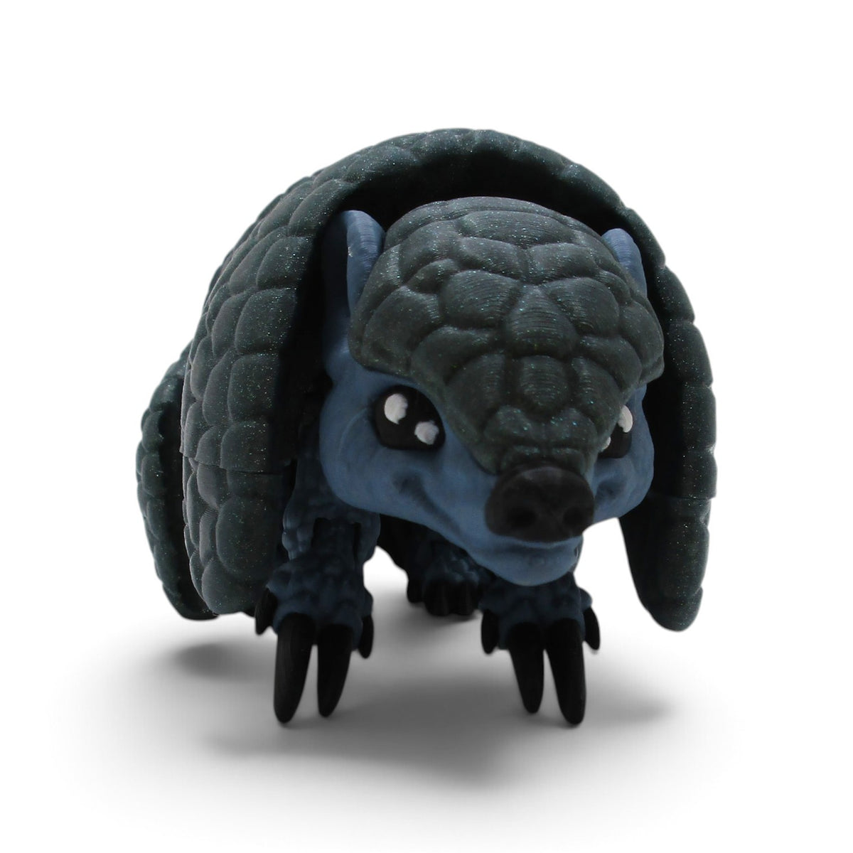 Flutterby Creations Rolo 3D printed flexi armadillo desk toy with dark blue textured armor scales on white background