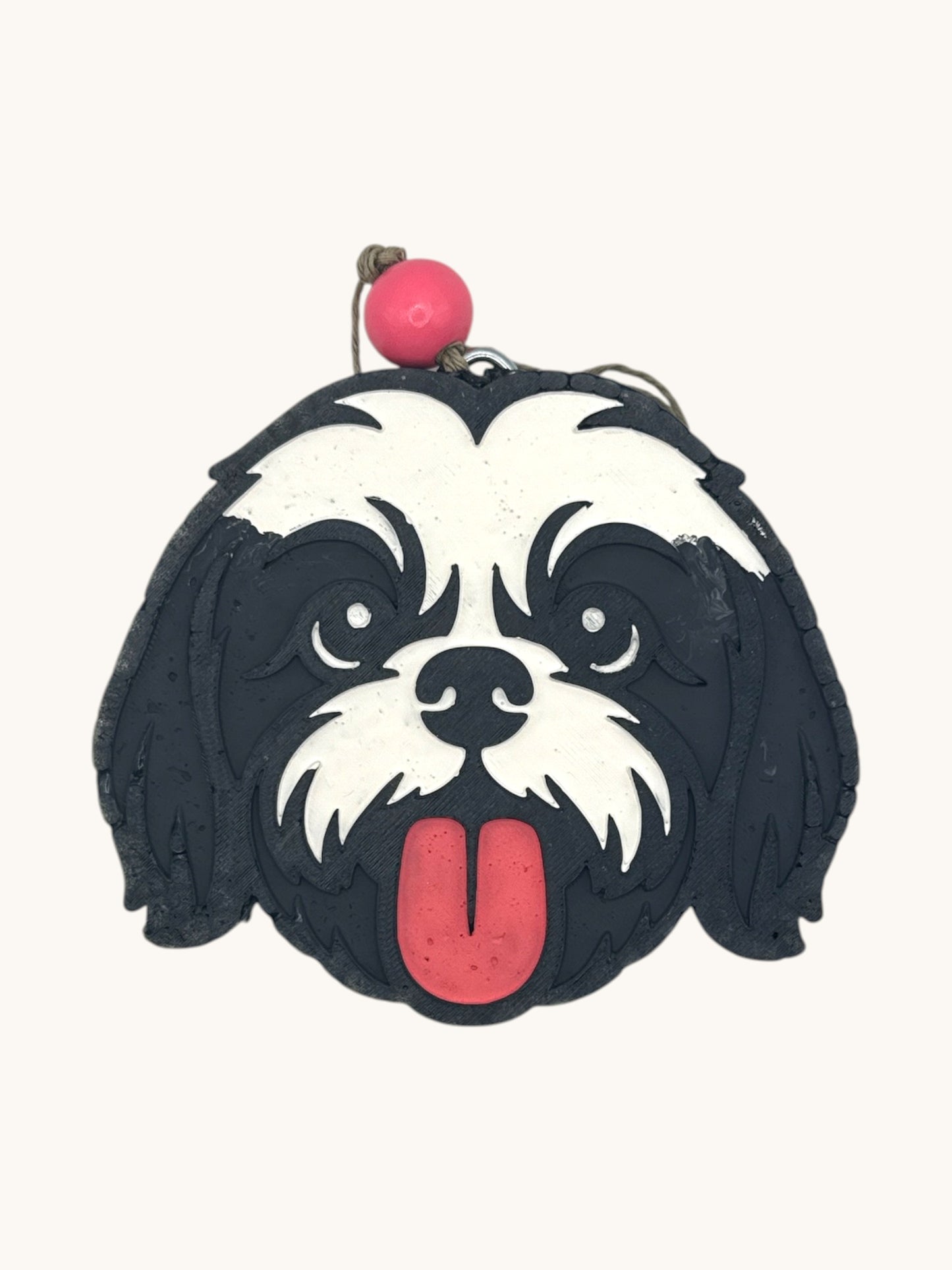 Flutterby Creations Shih Tzu car freshie, black and white dog face with pink tongue hanging out.