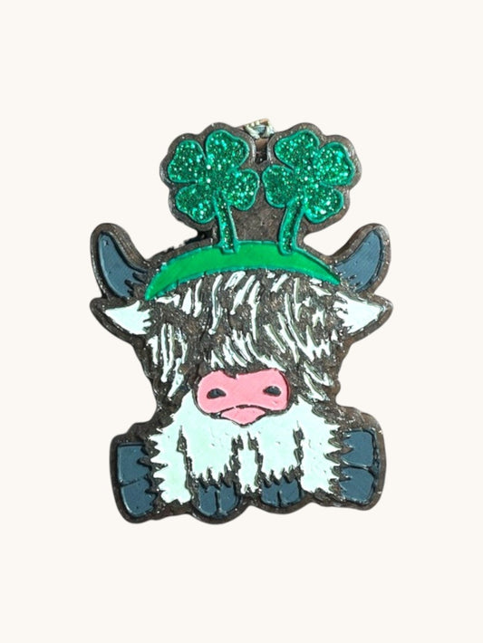Flutterby Creations St. Patty Day Highland Cow car freshie with green glitter shamrocks and a green bead.