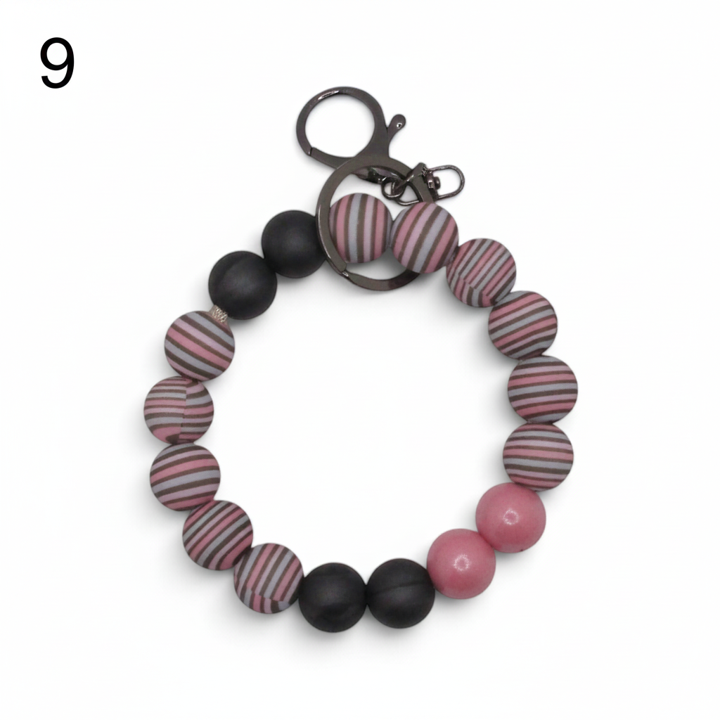 Flutterby Creations beadable wristlet featuring striped pink, grey, and black silicone beads with a metal keyring.
