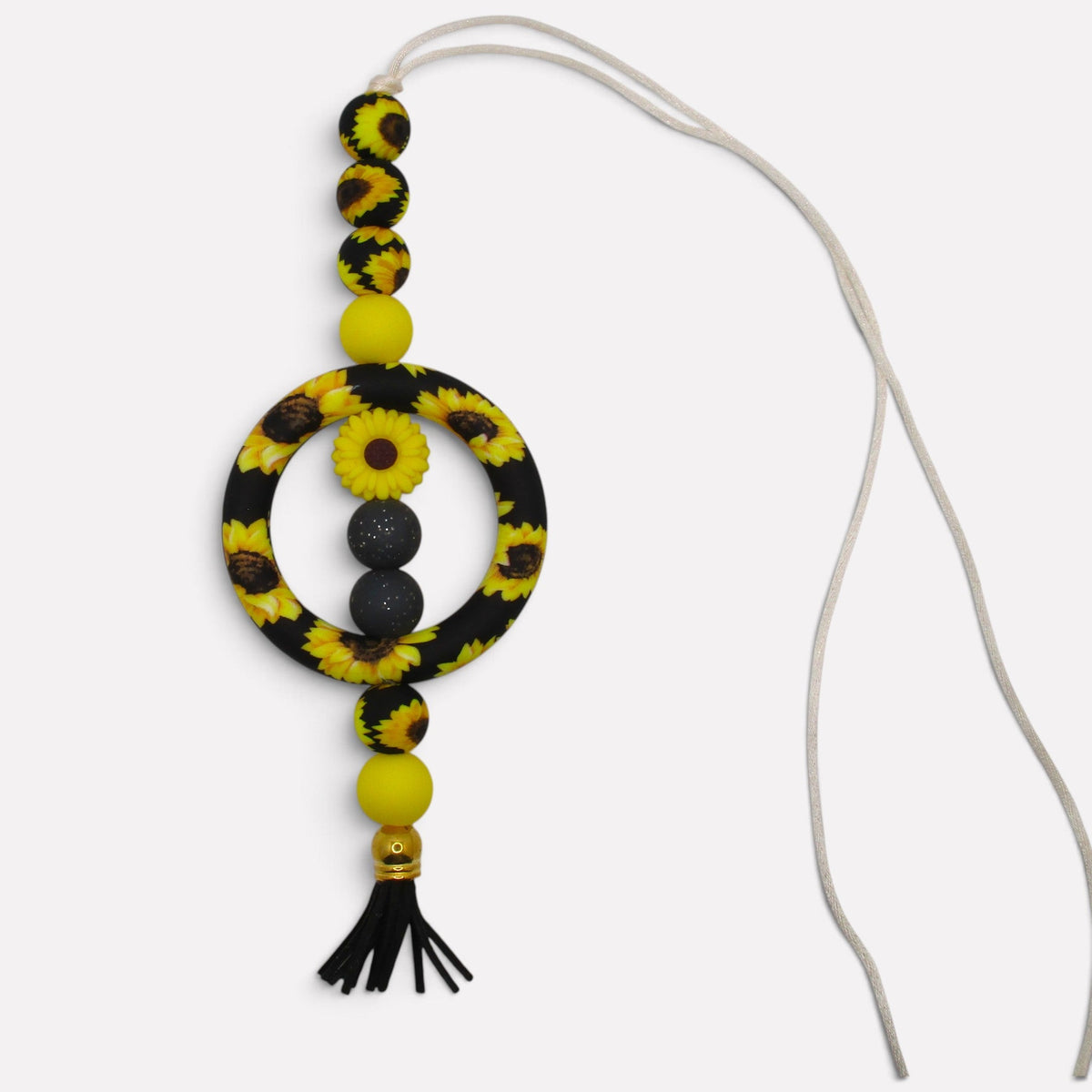 Flutterby Creations handmade beadable car charm featuring sunflower patterned beads, yellow spheres, and a black tassel