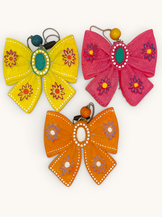 Flutterby Creations yellow, pink, and orange western bow freshies with floral accents and conch centerpieces.