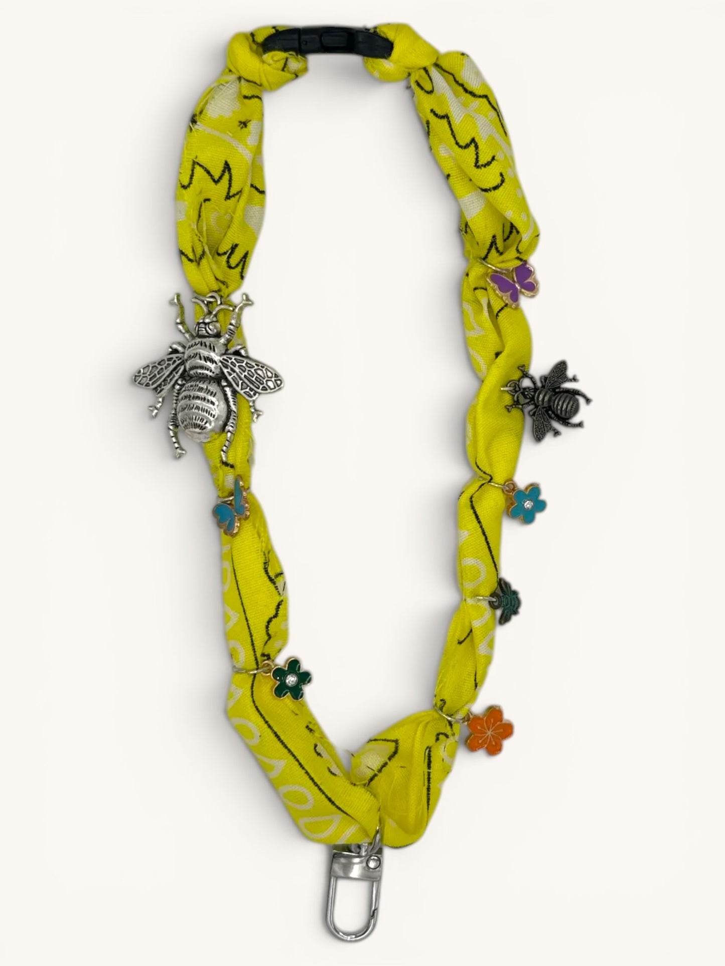 Flutterby Creations yellow fabric freshie hanger with bee and butterfly charms and a metal clasp.